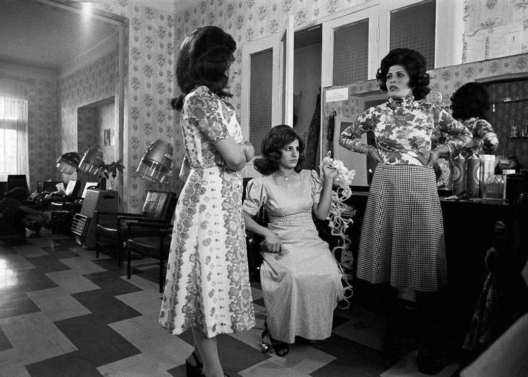 Three Iranian women with styled hair in a hair salon.